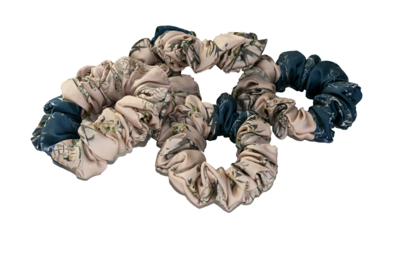 Two-toned scrunchies made from printed Satin. two thirds are desert sand colored and one third is blue.